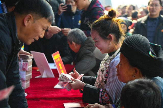 Villagers in Shibadong Village, Huayuan County, Xiangxi, Hunan, checked the industrial income money issued by the county (taken on January 17, 2019).